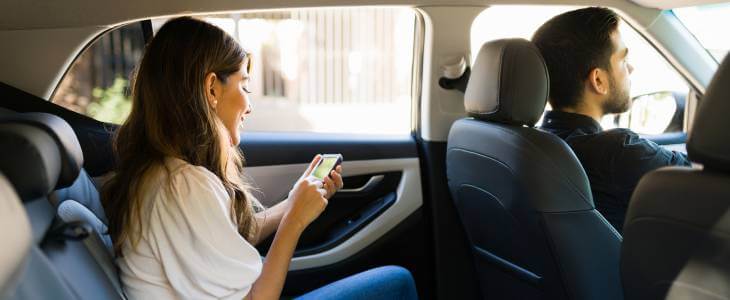 Female passenger in the backseat of a rideshare vehicle